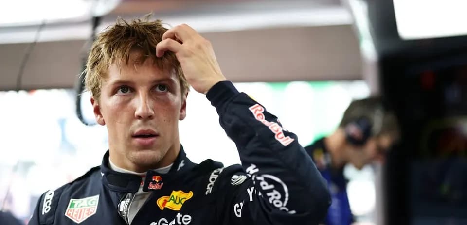 Driver adjusting hair in pit area during event