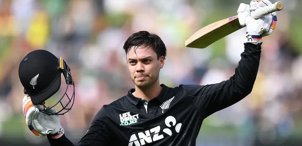 Cricketer celebrating with bat and helmet raised