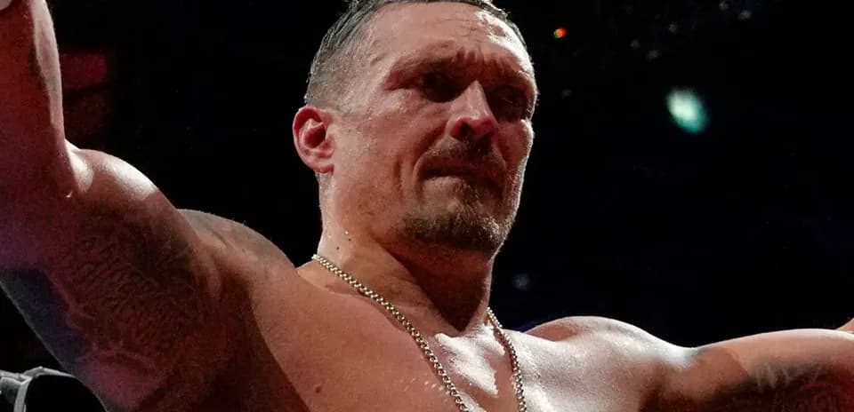Boxer celebrating victory with raised arms in ring