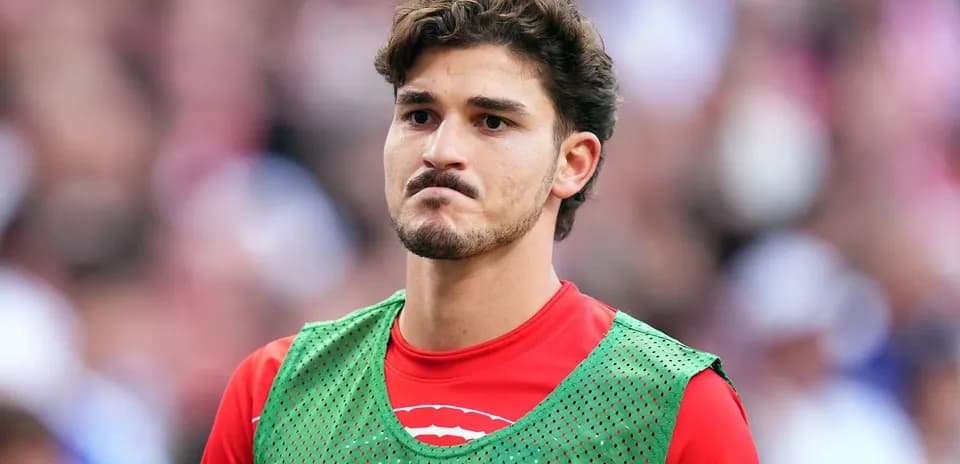 Player wearing training bib on sideline during match