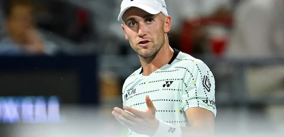 Tennis player gesturing during match on court