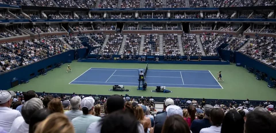 Crowd watching a tennis match at a stadium