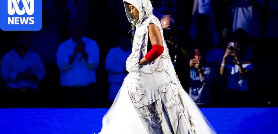 Person walking in unique fashion outfit on stage