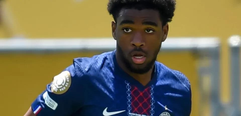 Player in blue PSG jersey during match action
