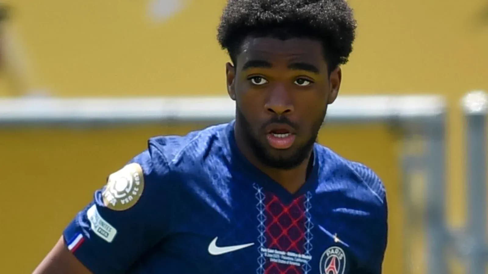 Player in blue PSG jersey during match action