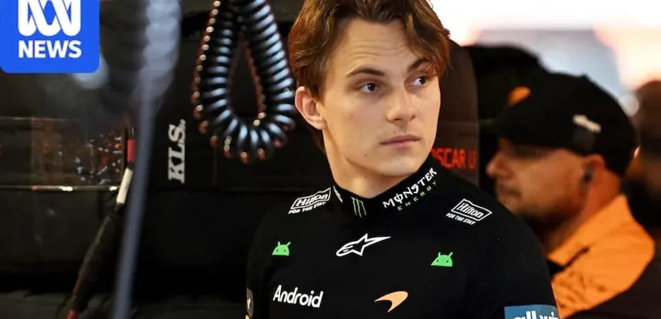 Driver in McLaren team gear in the garage