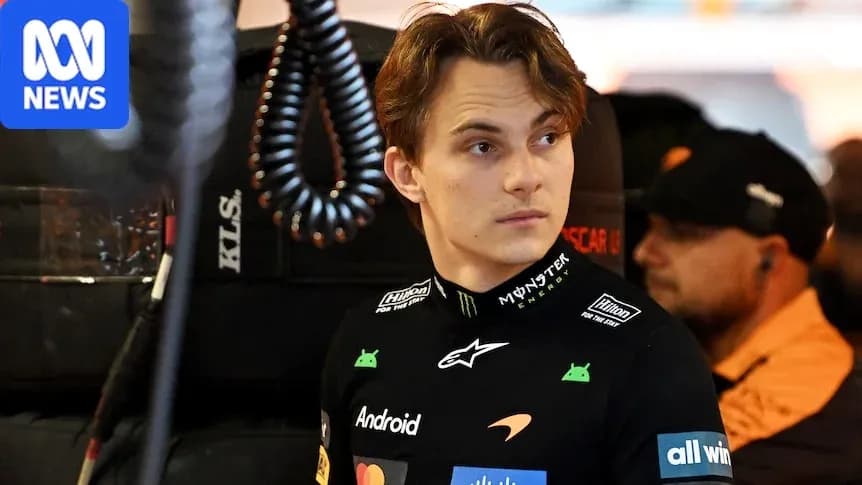 Driver in McLaren team gear in the garage