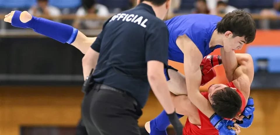 Two fighters competing in a grappling match
