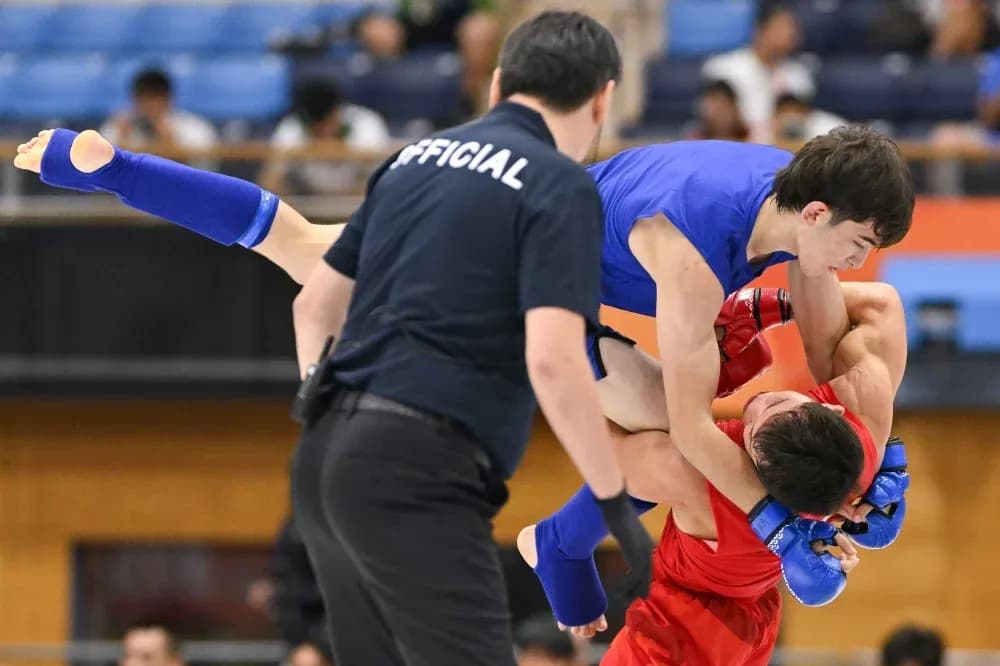 Two fighters competing in a grappling match