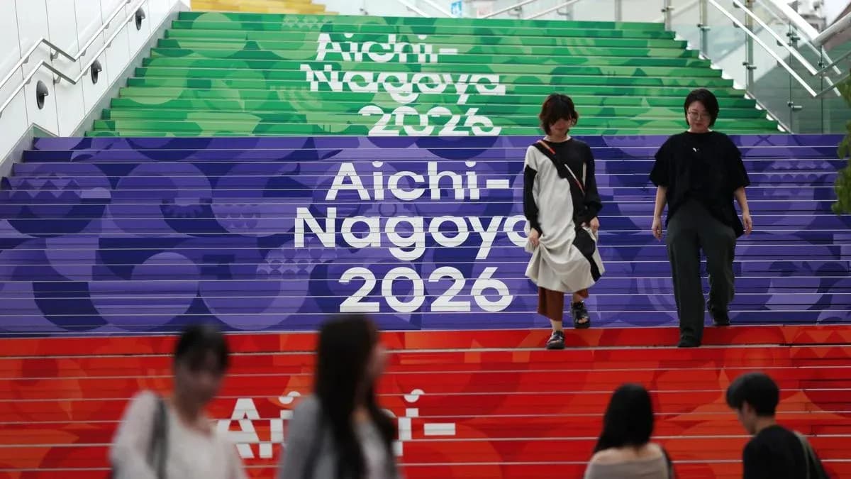 People walking down colorful stairs with event branding