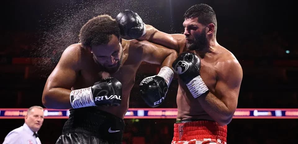 Two boxers exchanging punches in the ring