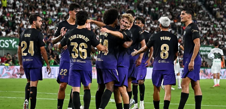 Barcelona players celebrating a goal on the field