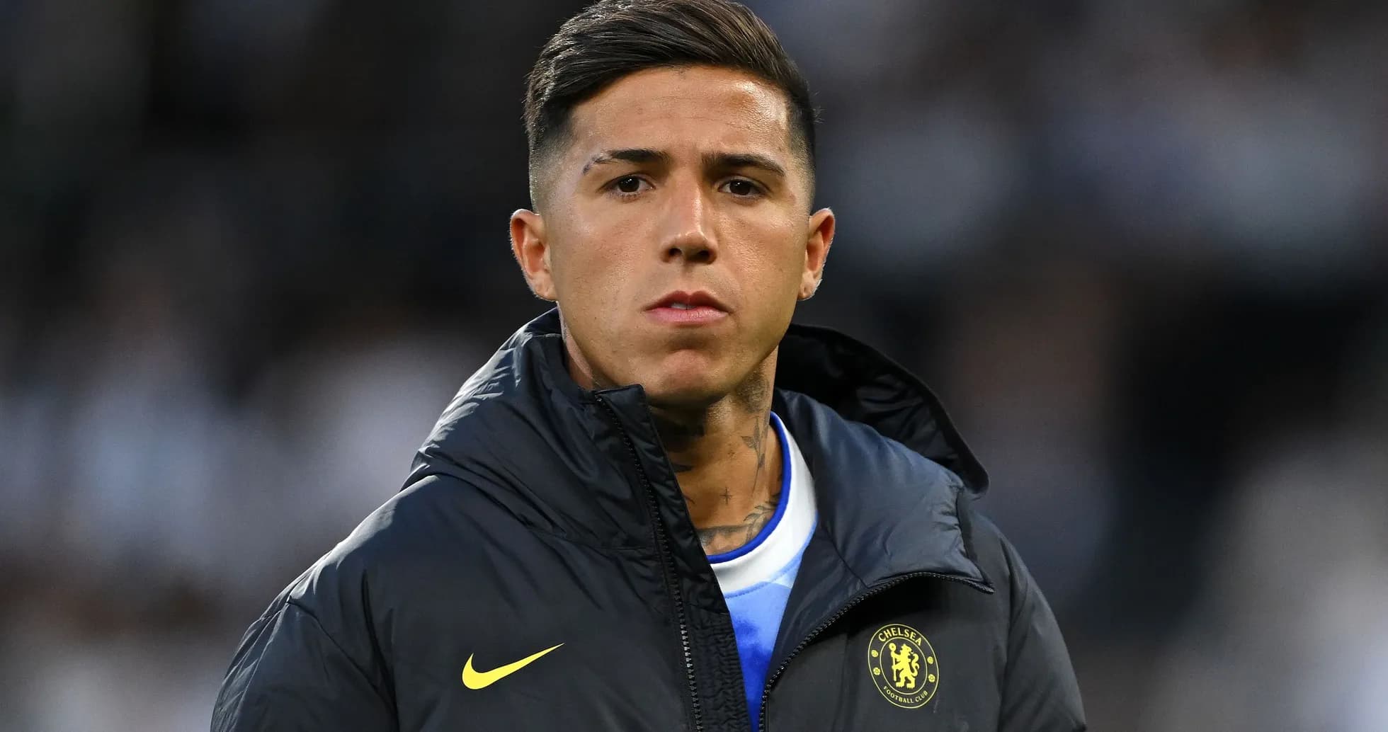 Player in Chelsea jacket on the sidelines