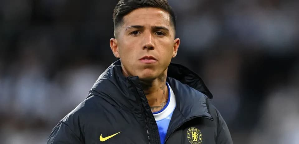 Player in Chelsea jacket on the sidelines