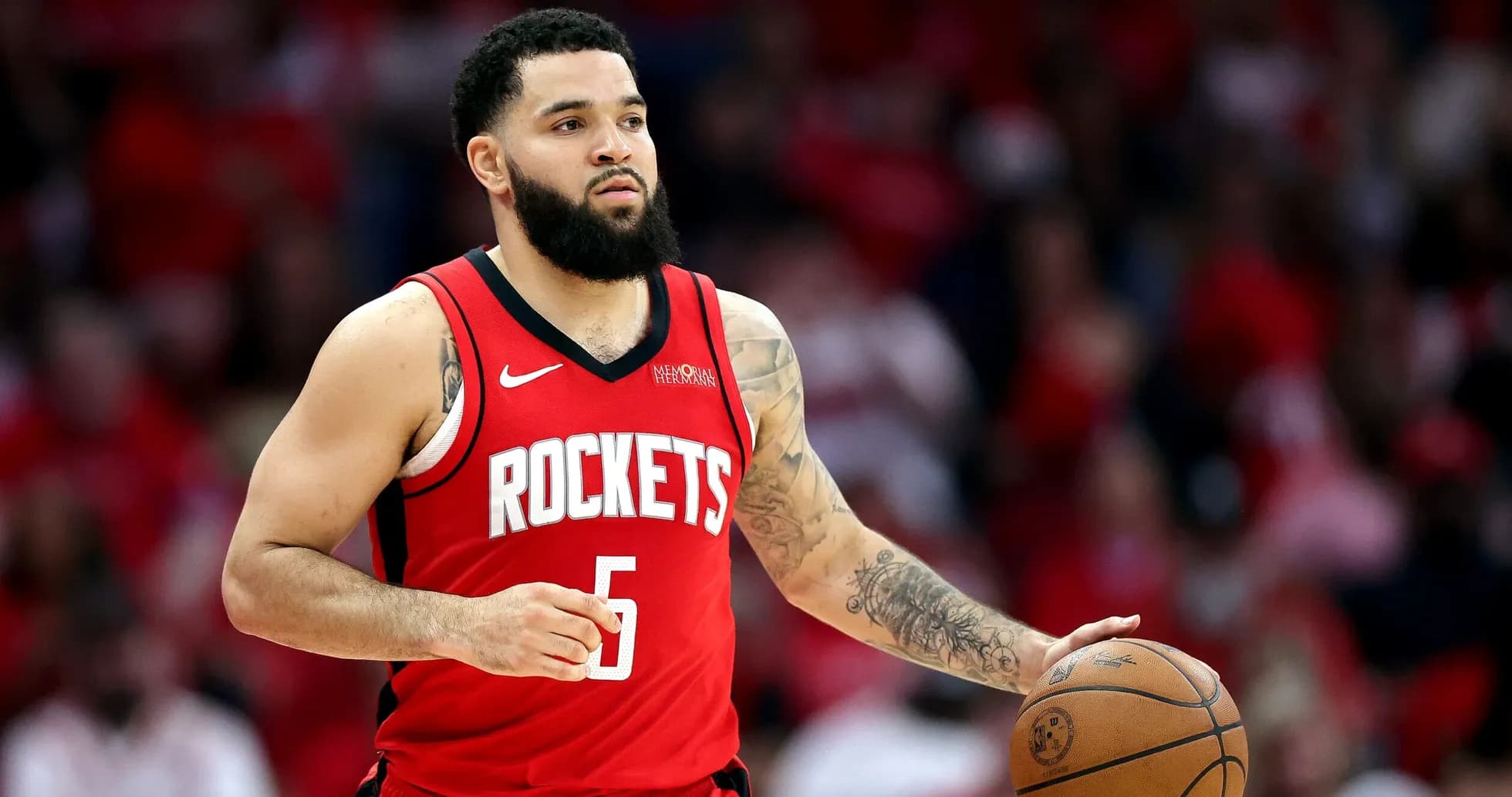 Player dribbling basketball in red Rockets jersey