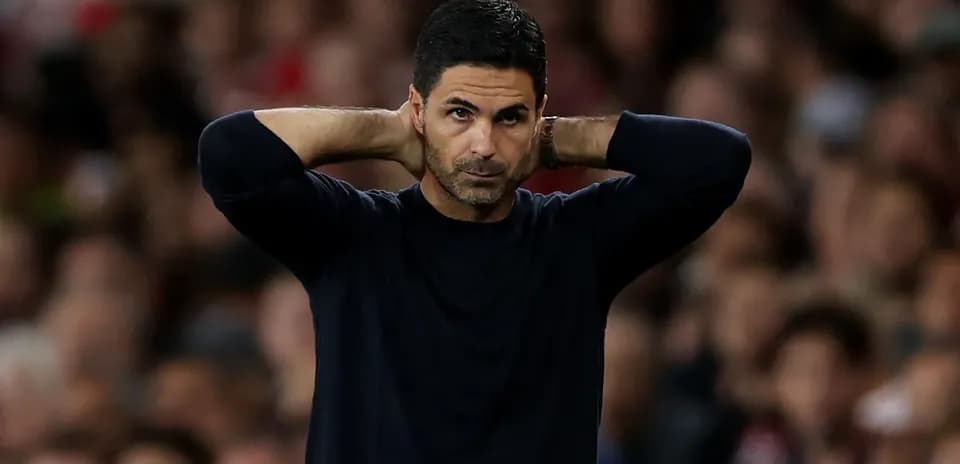 Manager with hands behind head during match