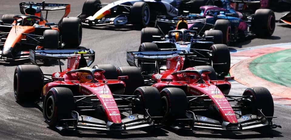 Two Ferrari cars racing closely during a Formula 1 event