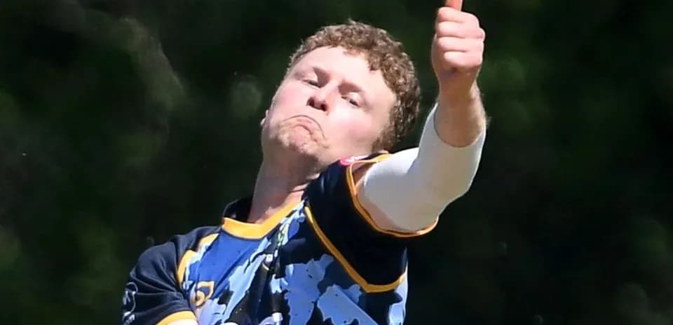 Cricketer bowling with a thumbs up gesture