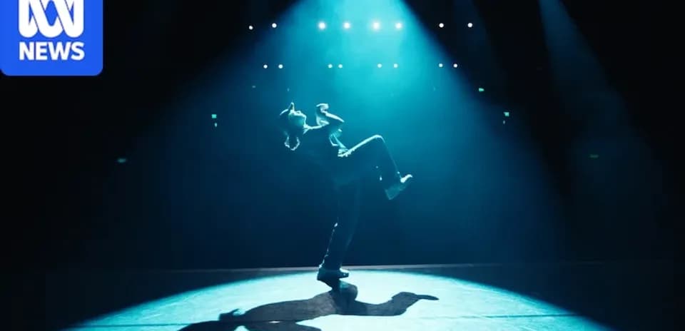 Dancer performing under dramatic stage lighting