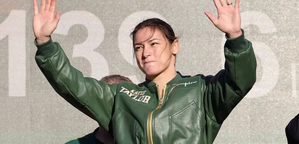 Female boxer waving during public event appearance