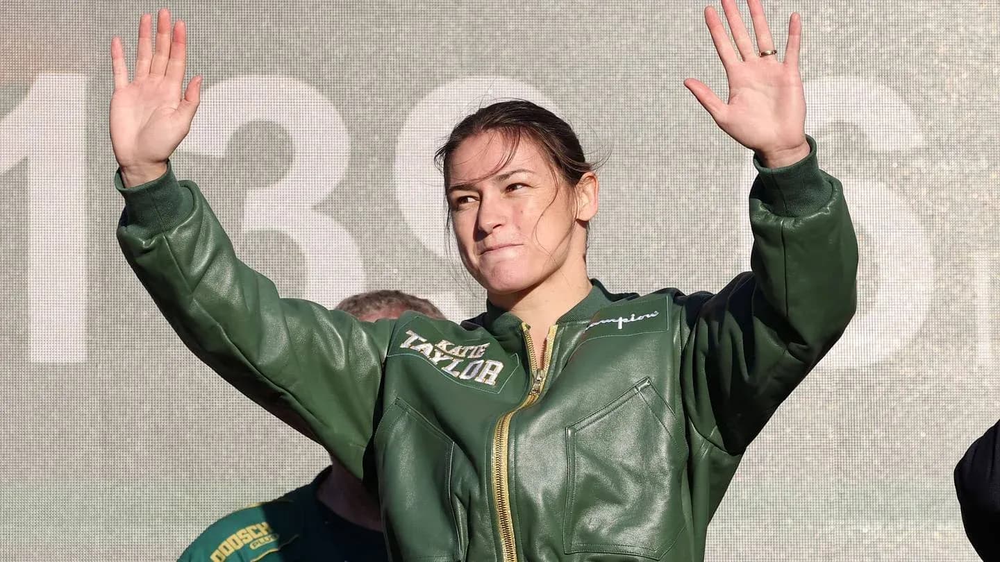 Female boxer waving during public event appearance