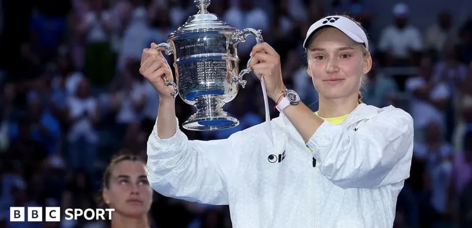 Player holding trophy with opponent in background