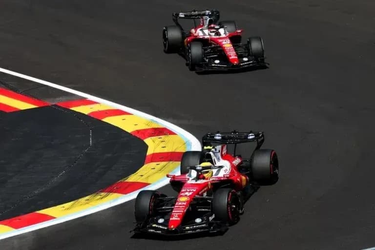 Two Ferrari cars racing on track during event