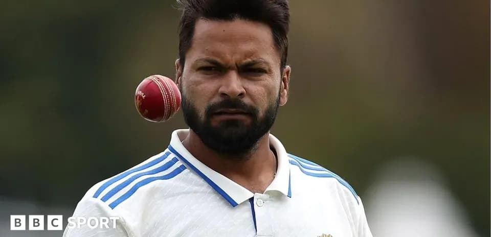 Cricketer preparing to bowl with cricket ball