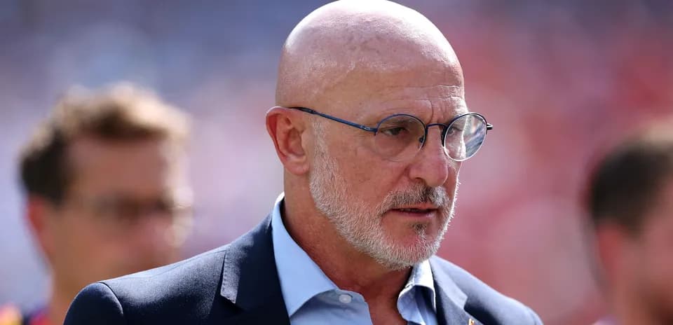 Man in glasses walking on the sidelines