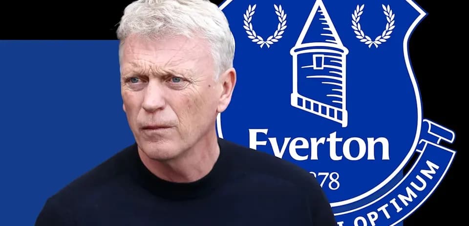 Man with short hair in front of Everton logo