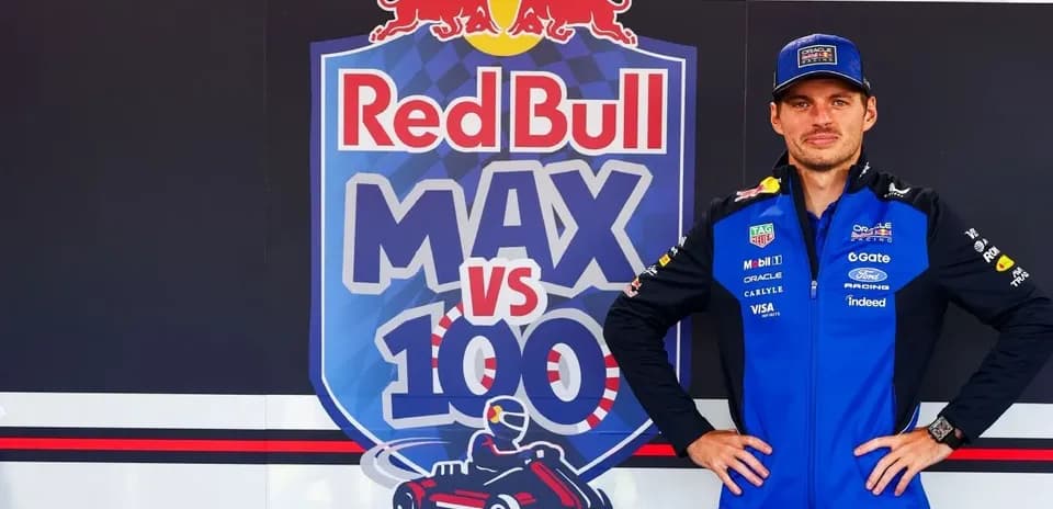 Driver posing in front of Red Bull promotional backdrop