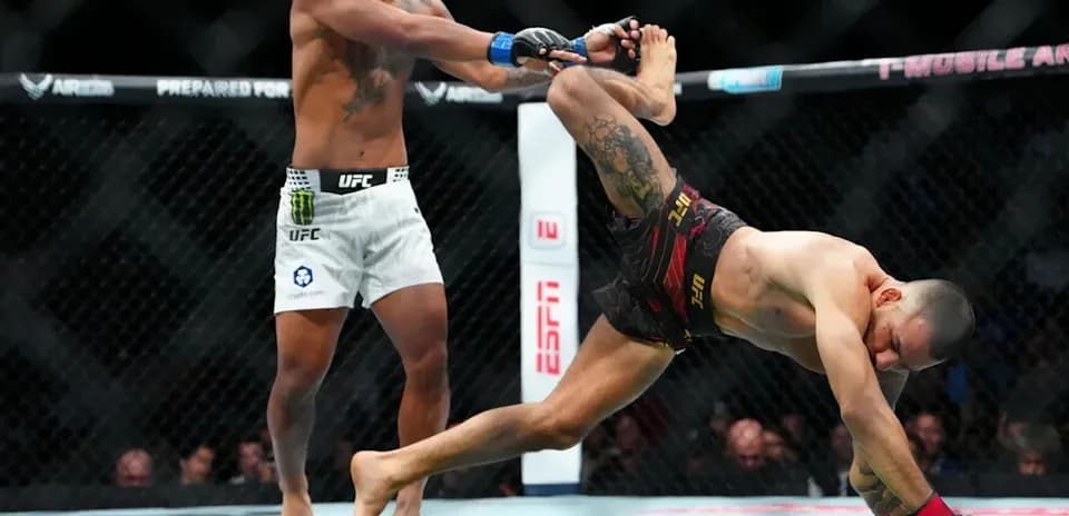 Fighter executing a takedown during MMA match