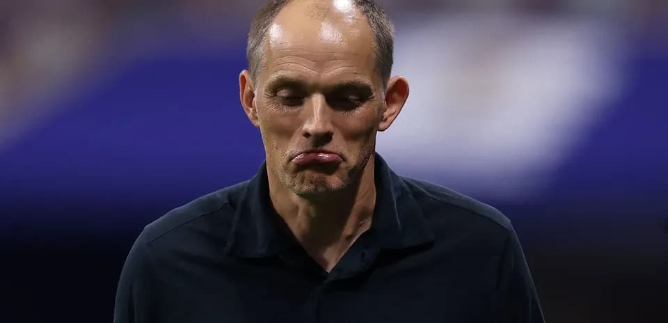 Coach walking off field with a serious expression