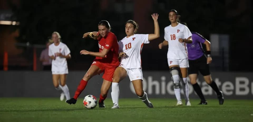 Two players competing for the ball during soccer match