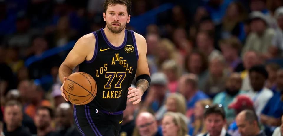 Player dribbling basketball during game against crowd