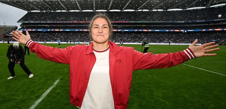 Woman celebrating on the field at a stadium
