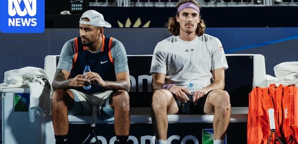 Nick Kyrgios and Stefanos Tsitsipas seated during match