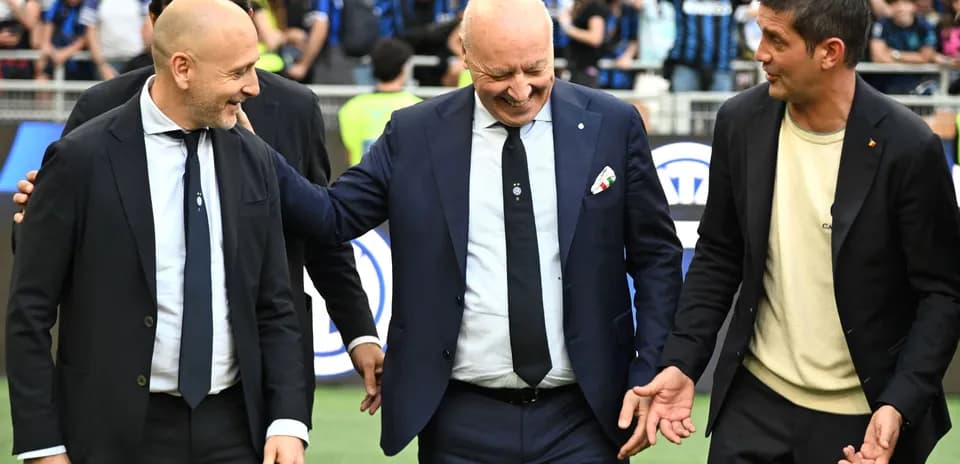 Three men interacting on the pitch before a match