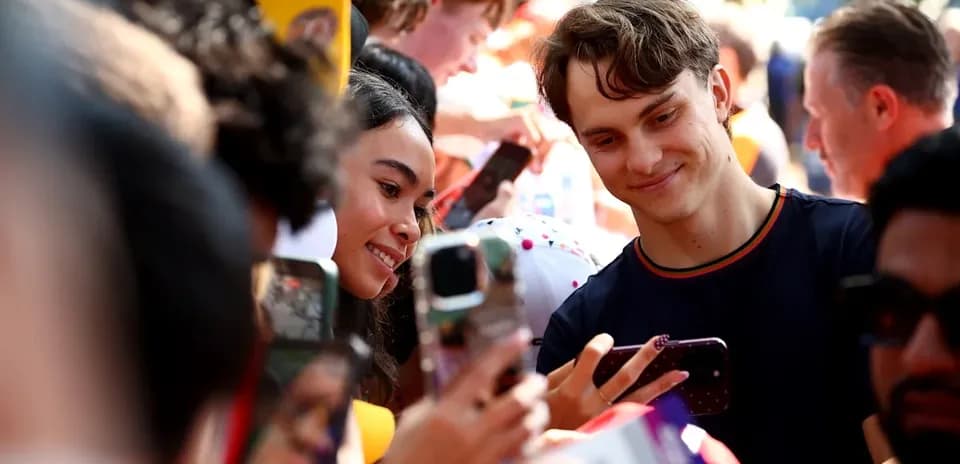 Fans taking selfies with a celebrity at event
