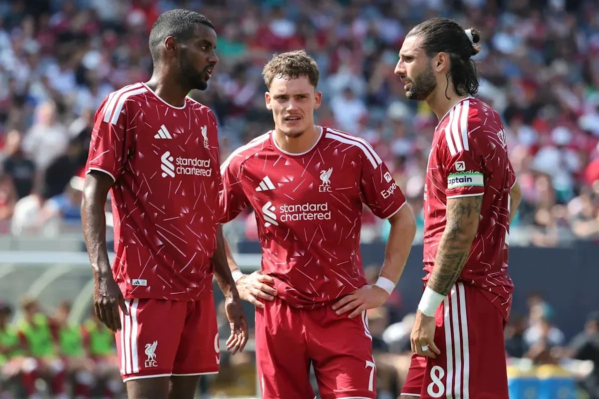Liverpool players discussing strategy during a match