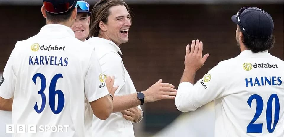Cricket team celebrating a wicket on the field