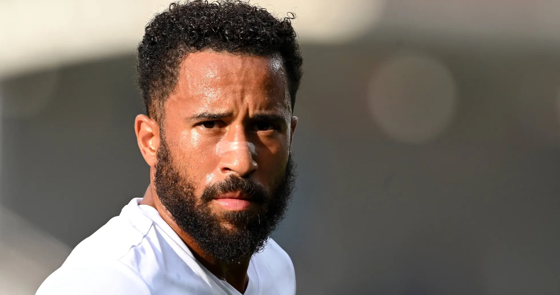 Player with beard looking towards the camera