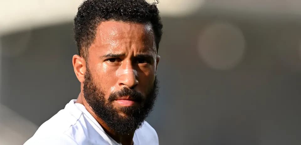 Player with beard looking towards the camera