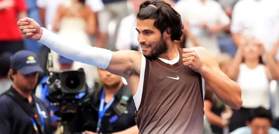 Tennis player celebrating victory with raised fist