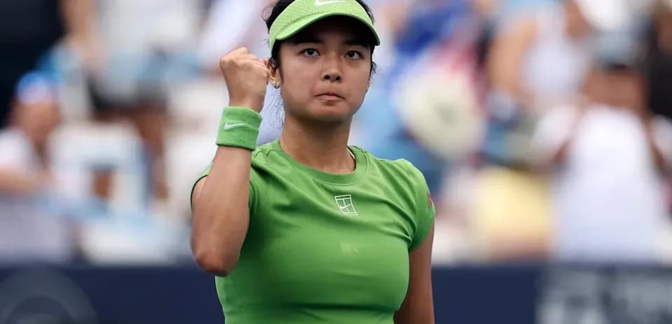 Tennis player celebrating victory with a fist pump