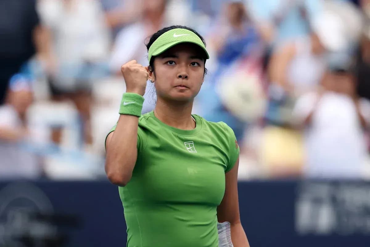 Tennis player celebrating victory with a fist pump