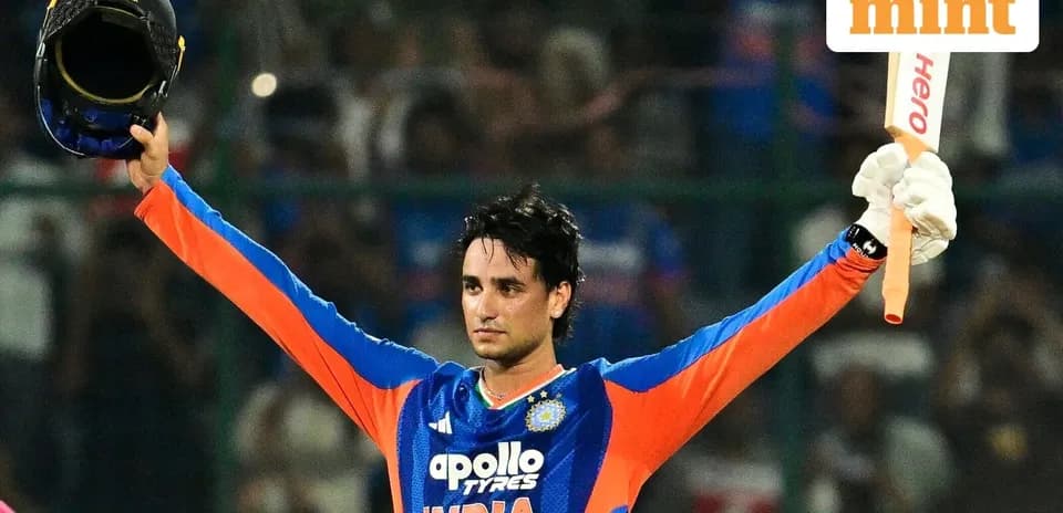 Cricketer celebrating with helmet and bat raised