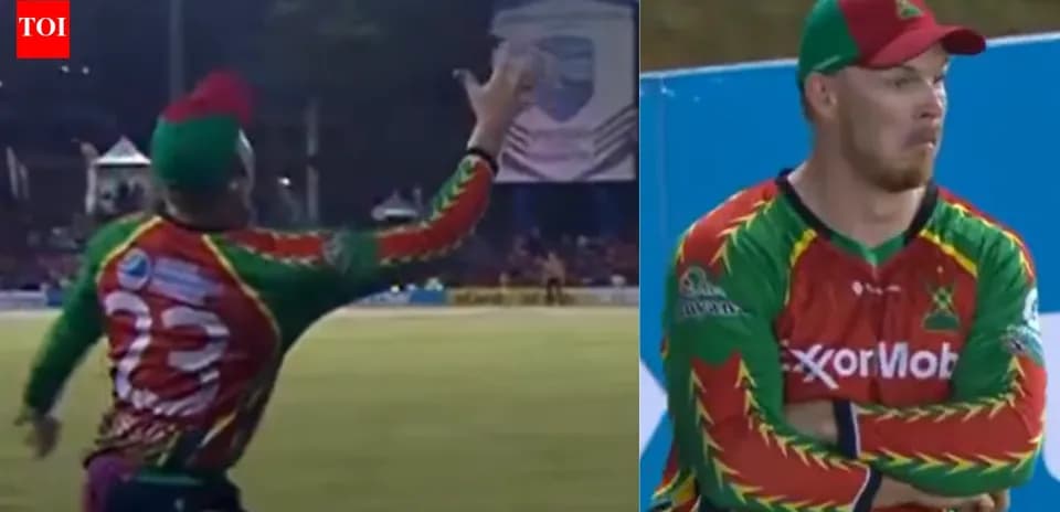 Cricketer attempting a catch during match action