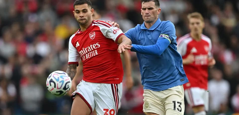 Two players battling for the ball on the field