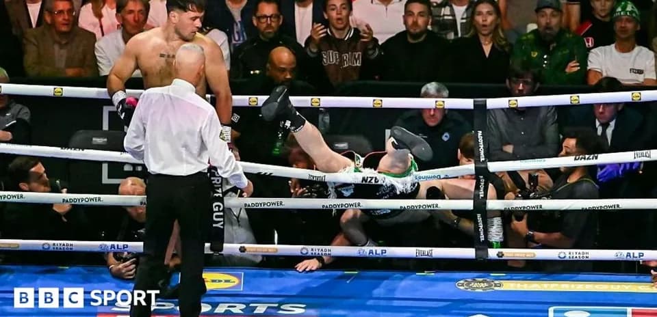 Boxer knocked out and falling outside the ring